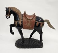Contemporary Tang-style black and red lacquered wooden model of a horse, on notch cut base, 74cm