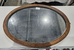 Georgian oval mahogany wall mirror, probably adapted from a dressing table mirror, with hooks for