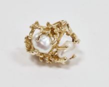 14k yellow gold and pearl dress ring of Brutalist form, the openwork textured head set with two