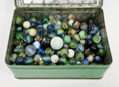 Vintage tin containing clear and opaque glass marbles