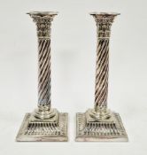 Pair of silver plated Corinthian column candlesticks with twisted stems and fluted square bases,