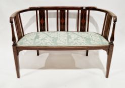 Edwardian mahogany inlaid salon settee having a curved back, green patterned upholstered seat and on