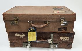 Two early to mid-20th century leather suitcases, each with partial applied travel stickers including