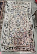 Eastern cream ground rug with central geometric medallion on floral field, floral spandrels and