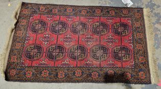 Eastern red ground rug with two rows of five elephant foot guls, geometric field, multiple geometric