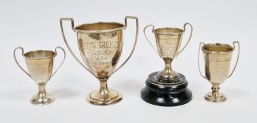 Four sterling silver small twin handled trophies, all engraved with presentational inscriptions, one
