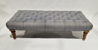 Modern ottoman stool, the top upholstered in a buttoned blue chevron fabric, on turned wooden