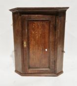 Two George III oak hanging corner cabinets, both with single panel doors, one having key and opening