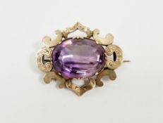 Victorian gold-coloured metal and purple stone brooch, probably Iolite, the claw set stone