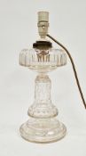 Early 20th century cut glass table lamp, with stepped lens-cut upper tier, honeycomb stem and lens-