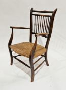Late 19th century Arts & Crafts elbow chair with spindleback and rush seat, on square shaped legs