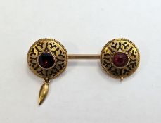 19th century 9ct yellow gold brooch in the Etruscan style, the bar brooch with two black enamel