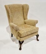 Parker Knoll wingback armchair upholstered in a yellow fabric, on cabriole legs, 96cm high x 77cm