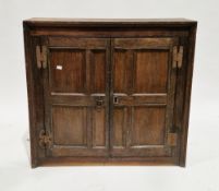 17th/18th century oak cupboard of square form, the two moulded panel doors opening to a single