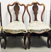 Pair of Victorian rosewood dining chairs, the shaped balloon backs with solid splats, stuffover