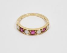 9ct yellow gold ruby and opal ring, claw set with a row of three round rubies and four round
