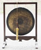 Early 20th century floorstanding dinner gong, the square mahogany frame holding a large circular