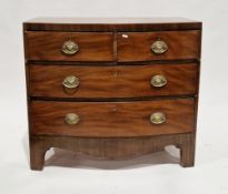 Early 19th century mahogany bowfronted chest, having two short and two long cockbeaded graduating