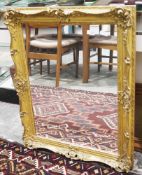 Giltwood rectangular wall mirror, the moulded frame decorated with scrolling foliage and flowers,