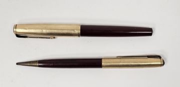 Two vintage Parker pens comprising a red cased fountain pen of gilt metal colour and a pencil