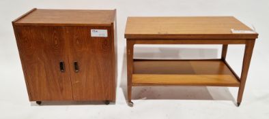 Mid-century teak coffee table/drinks trolley, the rectangular top folding over and swivelling to