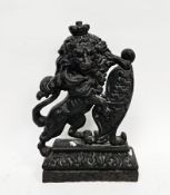 19th century cast iron doorstop in the form of a rampant lion resting on a shield, 39cm high