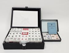 Modern cased Mahjong set, the plastic playing pieces unopened, retailed by John Lewis Limited,