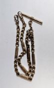 9ct gold fancy link albert chain with two lobster clasps and a T-bar, 21g approx. Condition Report