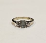 9ct white gold topaz and diamond ring, comprising a central claw-set emerald cut topaz flanked by