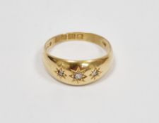 18ct gold and three-stone diamond gypsy-set ring having three old cut stones in star settings,