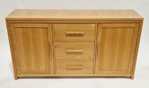 Modern oak-effect sideboard with three central drawers and two cupboard doors, all with block