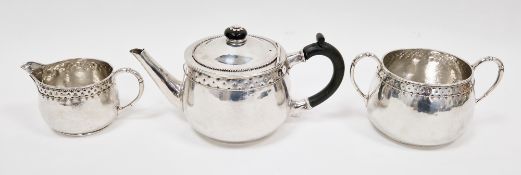 George V three piece silver tea service by Harold Edwin Landon, globular form with hammered and