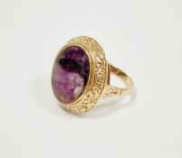 Antique 9ct yellow gold and Blue John stone ring, the oval cabochon Blue John set within a scrolling