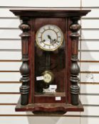19th century mahogany cased eight-day hanging wall clock, the glazed door with carved column sides