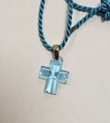 Lalique blue glass cross pendant with yellow metal mount, 3cm long, held on a blue cord necklace, in