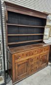 George III oak dresser, the top with moulded cornice over three plate shelves, the base with three
