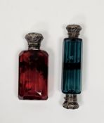 Two Victorian white metal mounted coloured glass scent bottles, the first ruby tint, faceted