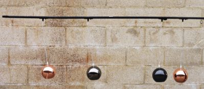 Ceiling channel light fitting with four adjustable lights, two with a copper finish globular shade