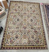 Large Eastern cream ground rug with floral field, multiple floral borders (some wear), 195cm x 138cm