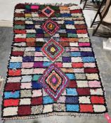 Large Moroccan style Boucherouite rug with four stepped lozenge medallions on multi-coloured