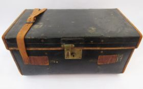 Leather-bound black trunk with brass fitting