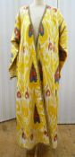 Uzbek 'Chapan' coat, yellow silk with ikat print patterns in rust and blue 'heart' shaped designs,