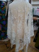 Lace net veil/shawl, 240cm wide x 124cm deep approx., two collars and a sleeve  Condition Report The