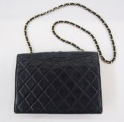 Chanel navy lambskin flap bag with gilt chain strap, embossed to the top edge with Chanel logo,