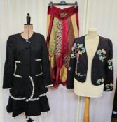 1990's black collarless coat with a tiered skirt, front pockets, edged with a white frayed detail,