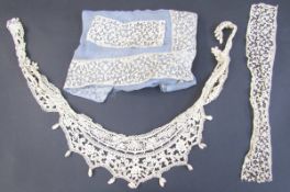 Quantity lengths of bobbin tape lace, scroll design including various lengths on blue chiffon