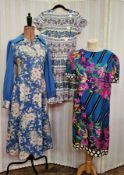 Assorted vintage dresses to include a blue wool shirt dress printed with pink flowers, an exotic