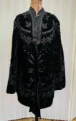 A Victorian black velvet evening cape, three quarter length heavily embroidered with faux jet, satin