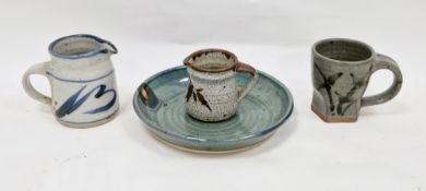 Four pieces of studio pottery to include a Colin Kellam jug with blue brushwork decoration on