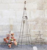 Two cone-shaped plant pot holders, a quantity of vintage terracotta pots and an antique iron plant